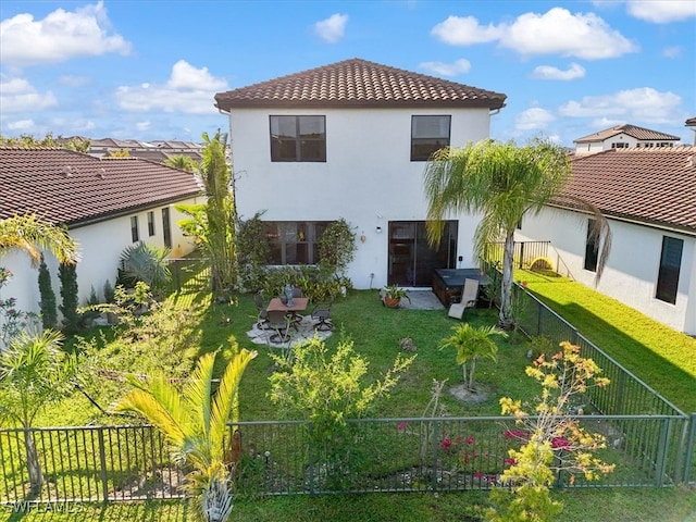 5448 Agostino Way, Ave Maria, FL 34142 - rear view of house with a fenced backyard, stucco siding, a yard, and a tiled roof