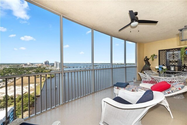 sunroom / solarium with a water view