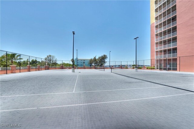 view of tennis court with fence