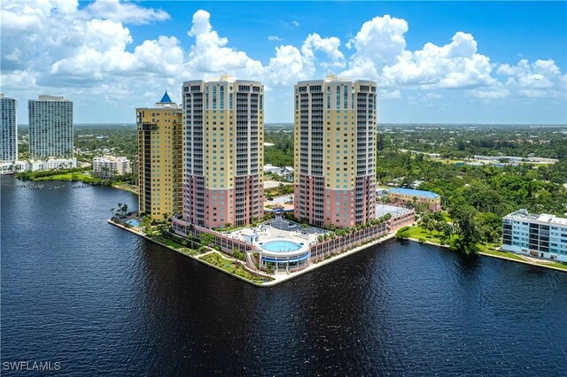 drone / aerial view featuring a city view and a water view