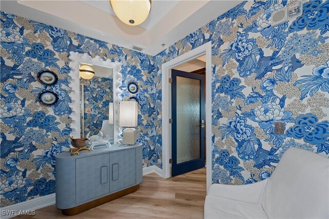 corridor featuring wallpapered walls and baseboards