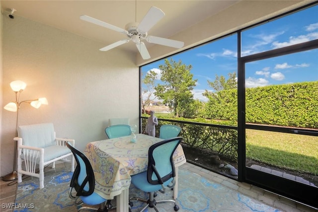 sunroom with ceiling fan and outdoor dining area
