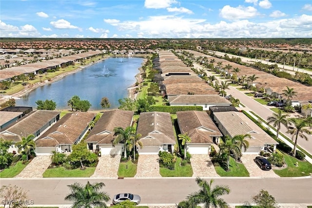 drone / aerial view featuring a water view and a residential view
