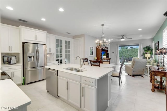 kitchen with white cabinets, recessed lighting, a sink, and appliances with stainless steel finishes