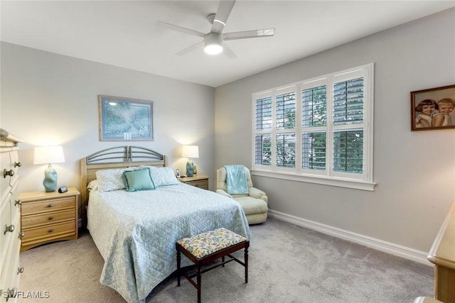 carpeted bedroom featuring baseboards and a ceiling fan