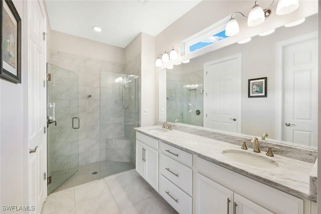 full bath featuring a shower stall, double vanity, and a sink
