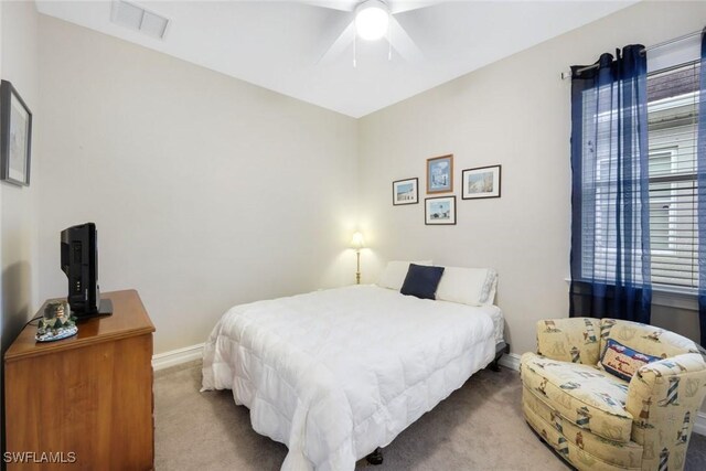 bedroom featuring ceiling fan, visible vents, baseboards, and carpet