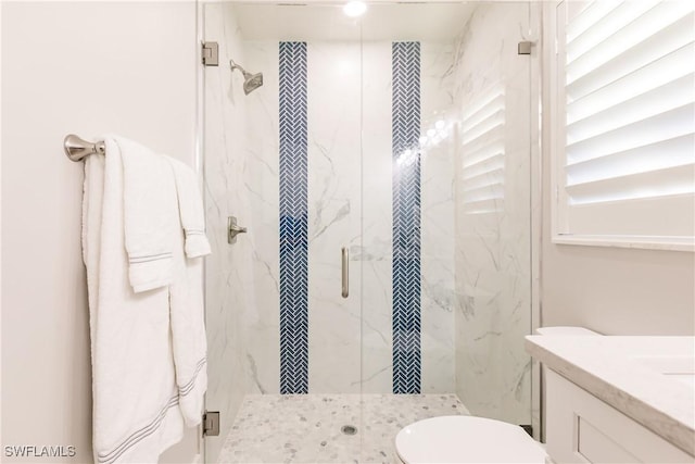 668 104th Ave N, Naples, FL 34108 - bathroom featuring vanity, a marble finish shower, and toilet
