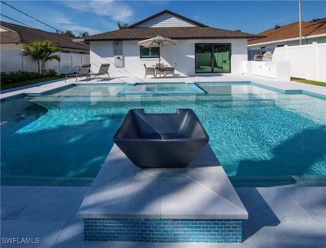 668 104th Ave N, Naples, FL 34108 - view of swimming pool featuring fence, a patio, and a pool with connected hot tub