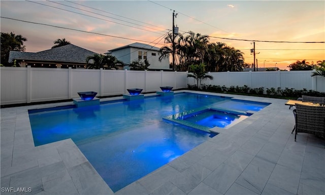 668 104th Ave N, Naples, FL 34108 - view of swimming pool featuring a fenced backyard, a patio area, and a pool with connected hot tub