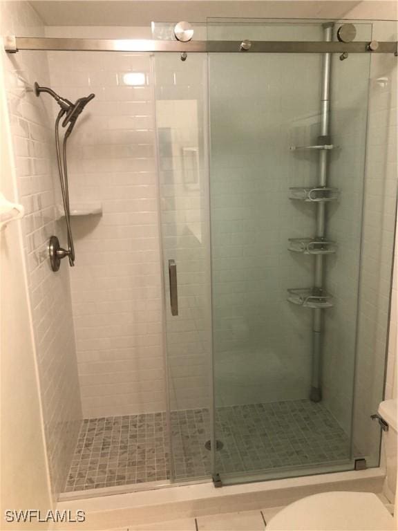 326 Bradstrom Cir Unit 103F, Naples, FL 34113 - bathroom featuring a stall shower and toilet