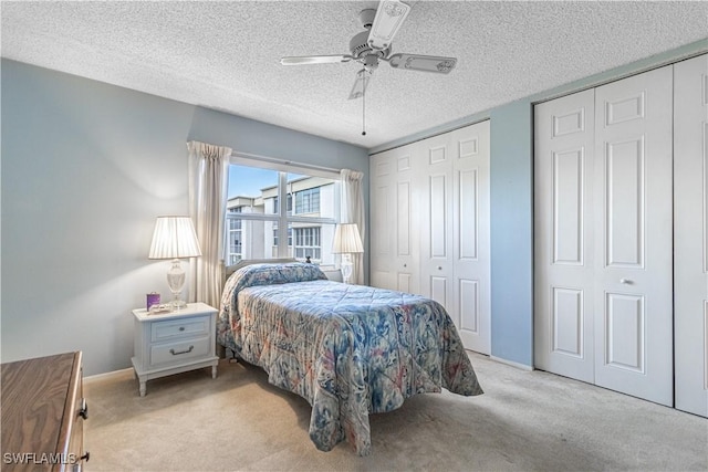 1624 Pine Valley Dr Unit 212, Fort Myers, FL 33907 - bedroom with baseboards, light colored carpet, a textured ceiling, and a ceiling fan