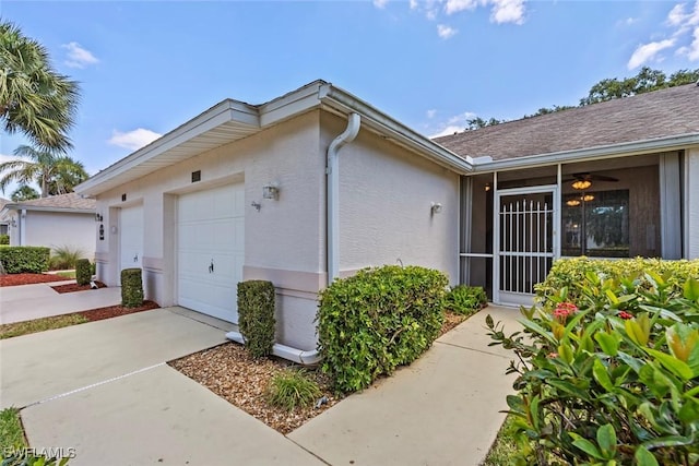 20657 Country Barn Dr, Estero, FL 33928 - view of property exterior featuring an attached garage, concrete driveway, and stucco siding