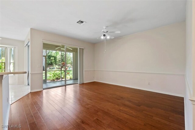 20657 Country Barn Dr, Estero, FL 33928 - spare room featuring hardwood / wood-style flooring, a ceiling fan, visible vents, and plenty of natural light