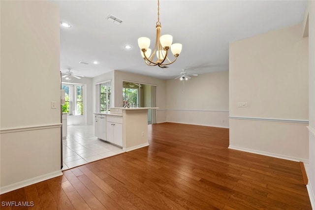 20657 Country Barn Dr, Estero, FL 33928 - interior space with baseboards, recessed lighting, visible vents, light wood finished floors, and ceiling fan with notable chandelier
