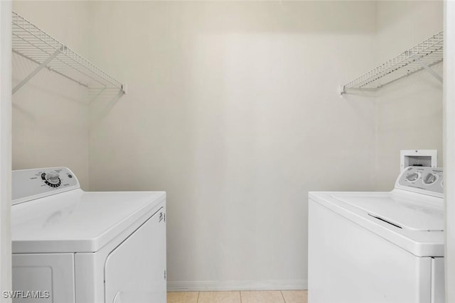 20657 Country Barn Dr, Estero, FL 33928 - washroom featuring laundry area, washing machine and clothes dryer, baseboards, and light tile patterned floors