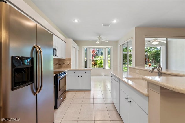 20657 Country Barn Dr, Estero, FL 33928 - kitchen featuring appliances with stainless steel finishes, light tile patterned floors, visible vents, ceiling fan, and a sink