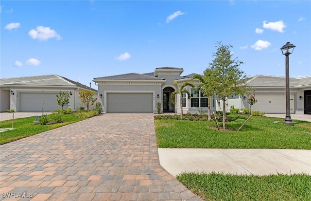 7060 Del Webb Oak Creek Blvd, North Fort Myers, FL 33917 - view of front facade with a garage, decorative driveway, a front yard, and stucco siding