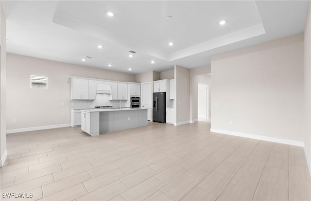 7060 Del Webb Oak Creek Blvd, North Fort Myers, FL 33917 - kitchen featuring black fridge, open floor plan, a raised ceiling, premium range hood, and recessed lighting