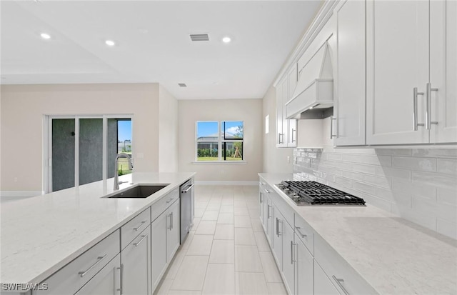 7060 Del Webb Oak Creek Blvd, North Fort Myers, FL 33917 - kitchen featuring a sink, stainless steel appliances, baseboards, custom exhaust hood, and backsplash