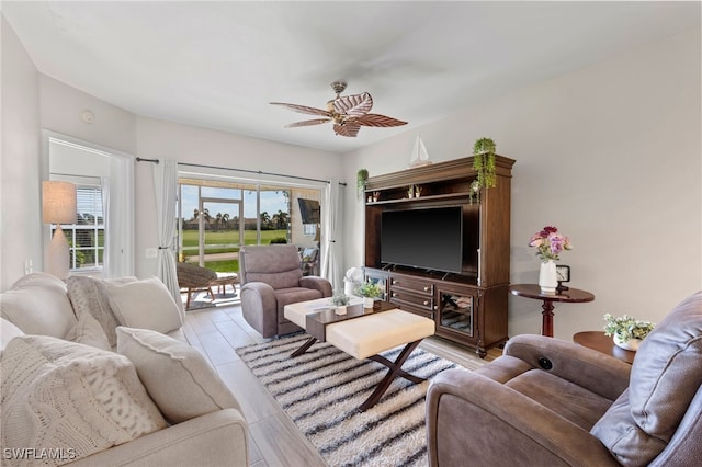 living area with ceiling fan and light wood-type flooring