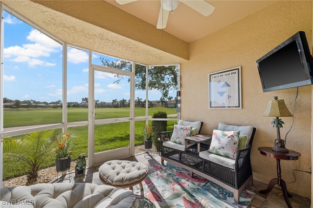 sunroom featuring a wealth of natural light, ceiling fan, and an outdoor hangout area