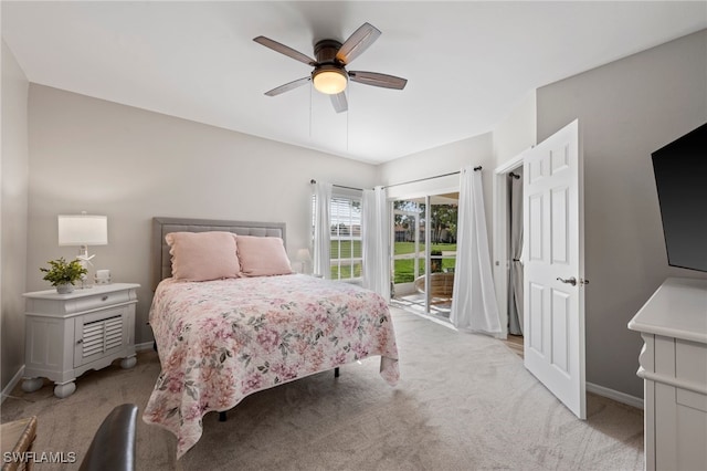 bedroom with access to exterior, ceiling fan, light carpet, and baseboards