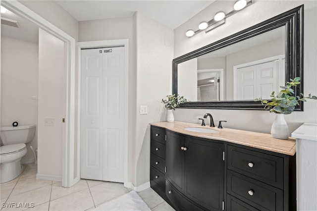 bathroom featuring toilet, a closet, tile patterned floors, and visible vents