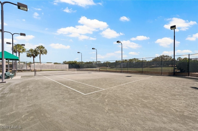 view of sport court featuring fence