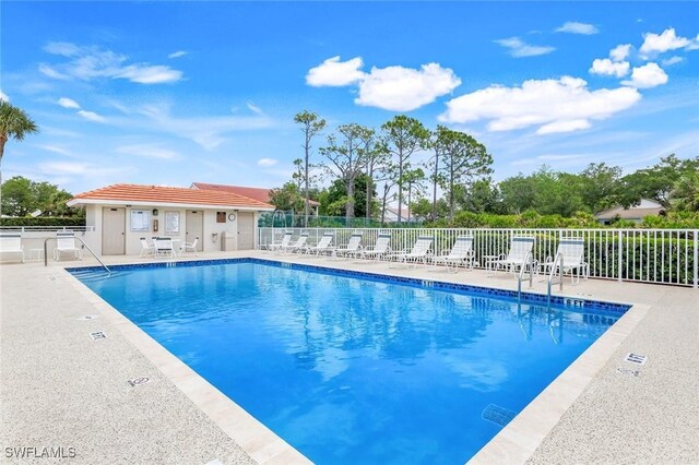 community pool featuring fence and a patio