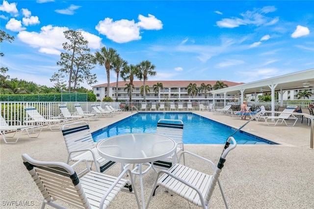 pool featuring a patio area and fence