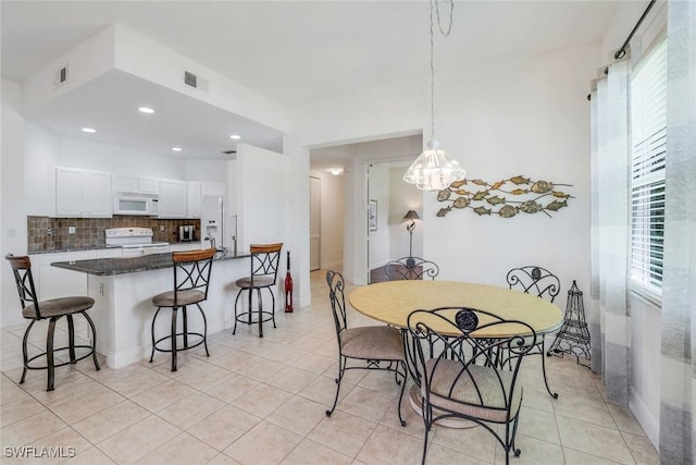 dining area featuring recessed lighting, a notable chandelier, visible vents, and light tile patterned floors
