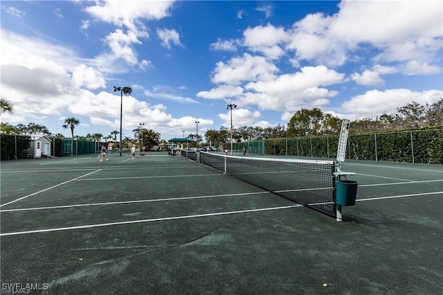 view of sport court featuring fence