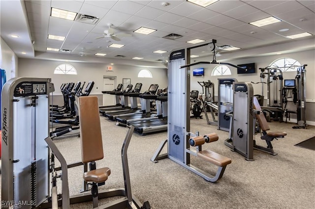 gym with visible vents, a ceiling fan, and a drop ceiling