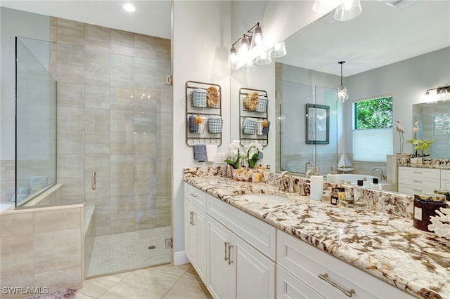 full bath with a shower stall, tile patterned floors, and vanity