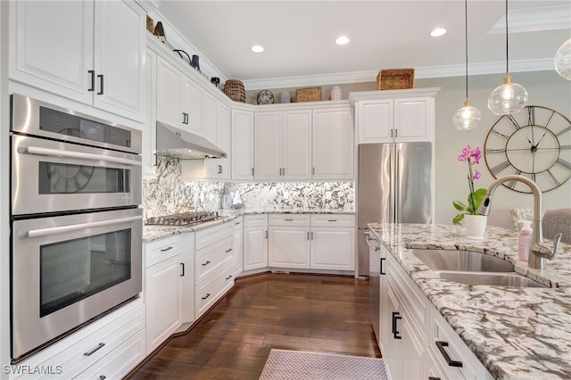 kitchen featuring a sink, stainless steel appliances, white cabinets, under cabinet range hood, and dark wood-type flooring