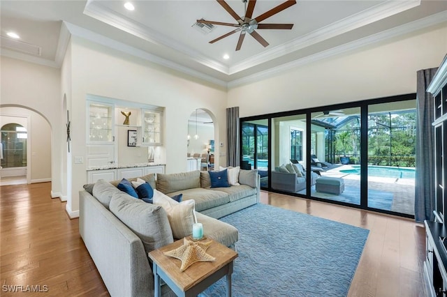 14501 Marsala Way, Naples, FL 34109 - living room with arched walkways, plenty of natural light, ceiling fan, crown molding, and recessed lighting