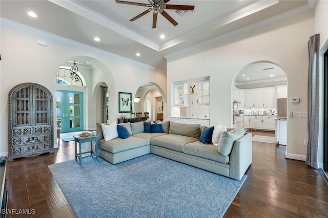 14501 Marsala Way, Naples, FL 34109 - living area with arched walkways, ceiling fan, dark wood-style flooring, ornamental molding, and recessed lighting
