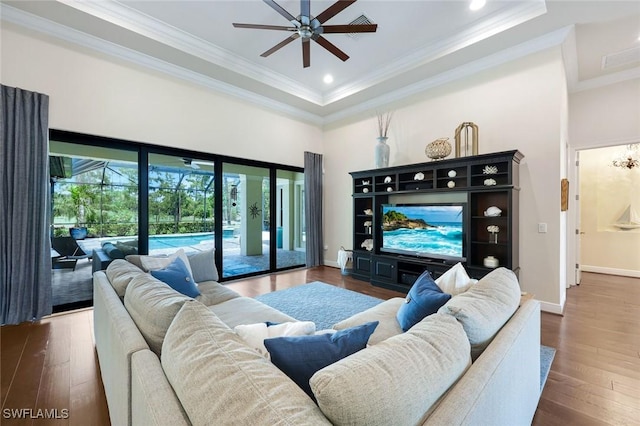 14501 Marsala Way, Naples, FL 34109 - living area with a ceiling fan, a sunroom, hardwood / wood-style flooring, a tray ceiling, and crown molding
