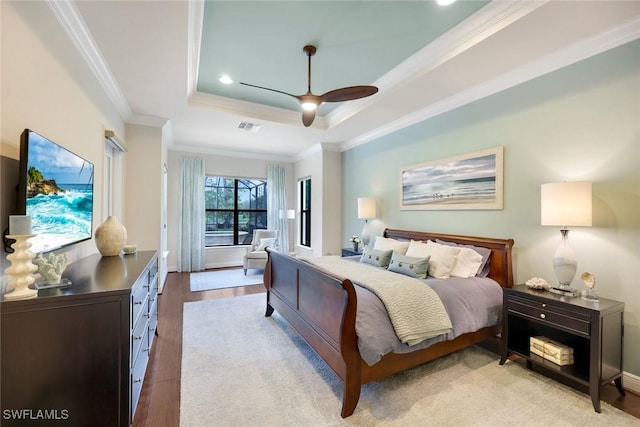 14501 Marsala Way, Naples, FL 34109 - bedroom with a raised ceiling, ornamental molding, light wood finished floors, ceiling fan, and recessed lighting