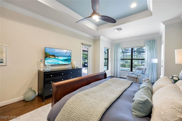14501 Marsala Way, Naples, FL 34109 - bedroom with dark wood-type flooring, a tray ceiling, crown molding, and ceiling fan