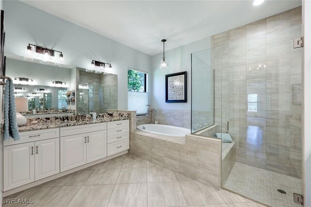 14501 Marsala Way, Naples, FL 34109 - full bathroom featuring a garden tub, vanity, a stall shower, and tile patterned flooring