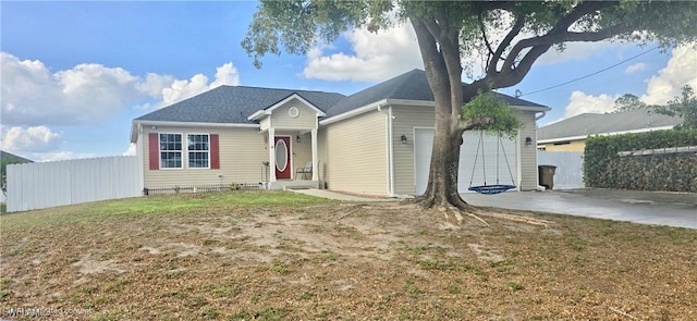 ranch-style home featuring a garage, fence, driveway, and a front yard