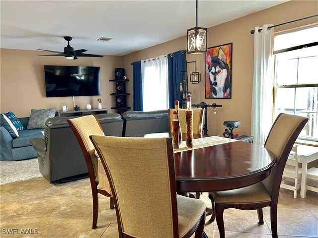 dining room with light tile patterned floors, a ceiling fan, and visible vents