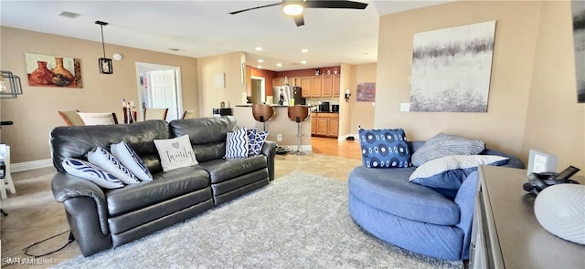 living room with baseboards, recessed lighting, light tile patterned floors, visible vents, and ceiling fan
