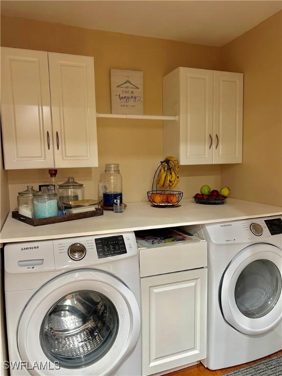 laundry area featuring washer / clothes dryer and cabinet space