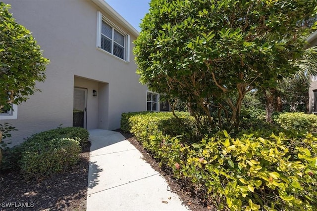 7099 Pond Cypress Ct Unit 102, Naples, FL 34109 - view of property exterior featuring stucco siding