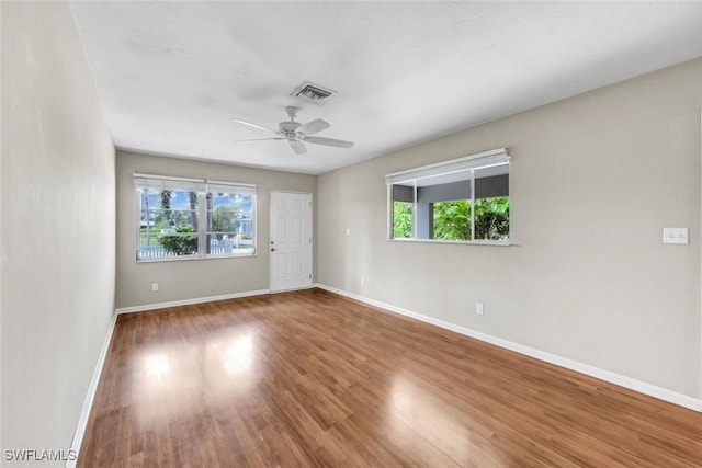 547 103rd Ave N, Naples, FL 34108 - empty room featuring plenty of natural light and baseboards