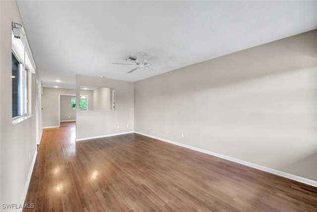 547 103rd Ave N, Naples, FL 34108 - empty room with baseboards, wood finished floors, and a ceiling fan