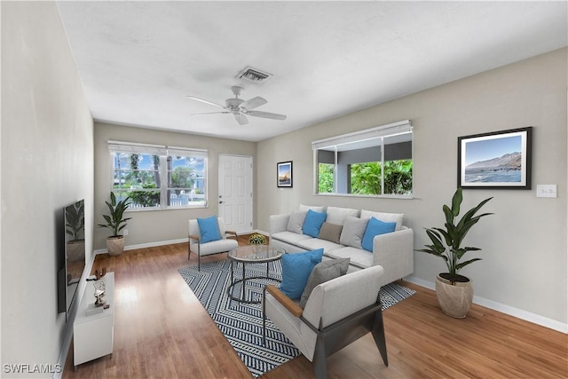 547 103rd Ave N, Naples, FL 34108 - living area with plenty of natural light, baseboards, and wood finished floors